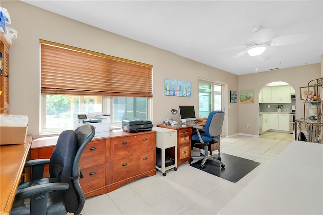 office with light tile patterned floors and ceiling fan