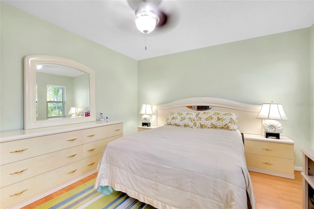 bedroom with light hardwood / wood-style floors and ceiling fan