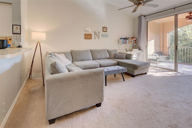 carpeted living room with ceiling fan