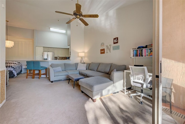 carpeted living room with ceiling fan