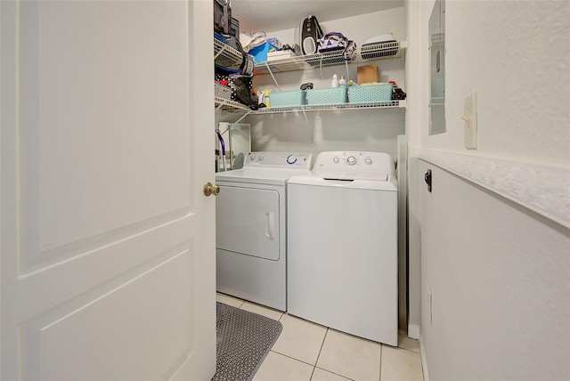 laundry area with light tile patterned floors and independent washer and dryer