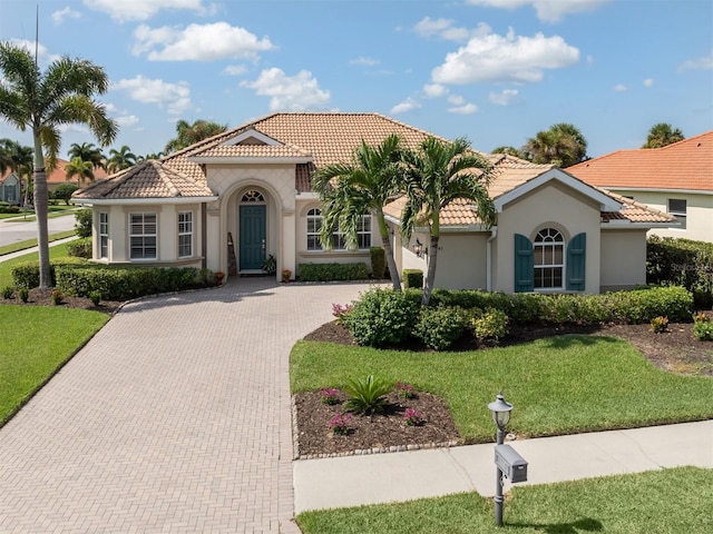 mediterranean / spanish-style house featuring a front yard