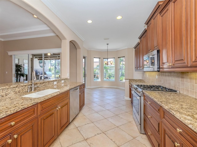 kitchen featuring decorative light fixtures, light stone counters, stainless steel appliances, and tasteful backsplash