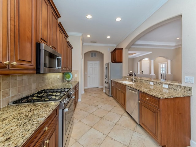 kitchen featuring sink, crown molding, tasteful backsplash, light stone counters, and stainless steel appliances