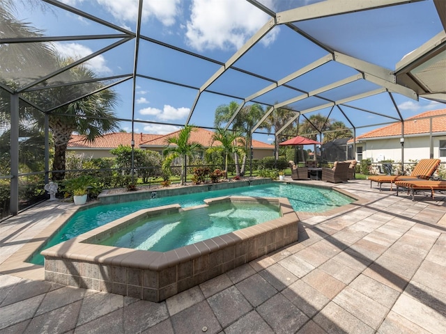 view of swimming pool with an in ground hot tub, a patio, and a lanai