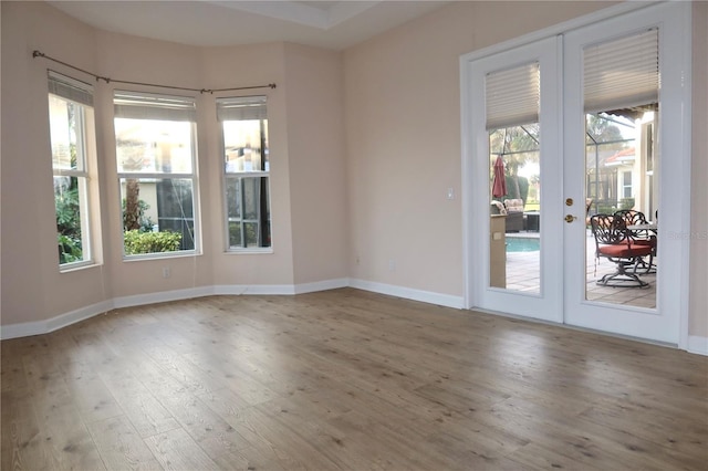 empty room featuring hardwood / wood-style floors and french doors