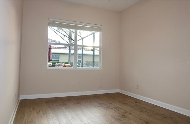 unfurnished room with a healthy amount of sunlight and wood-type flooring