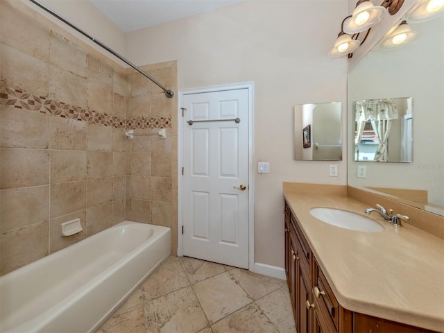 bathroom with vanity and tiled shower / bath