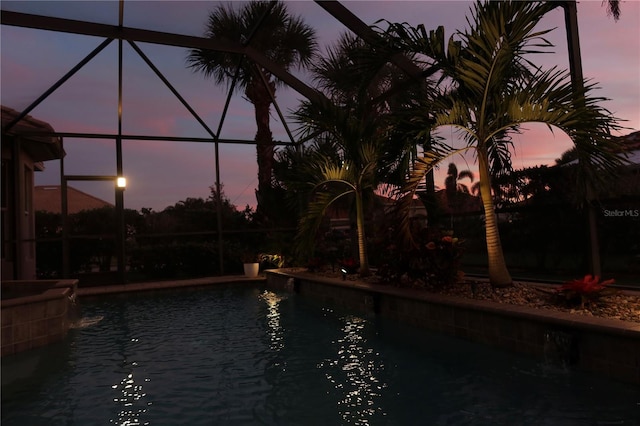 pool at dusk with glass enclosure