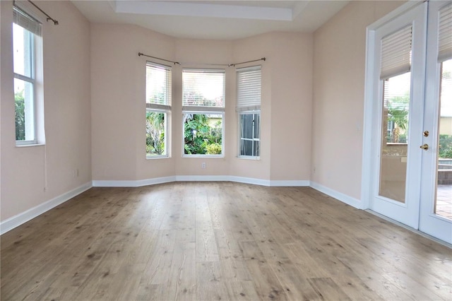 unfurnished room with french doors and light hardwood / wood-style floors