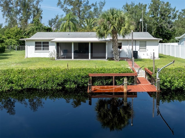 back of house with a sunroom, a water view, central air condition unit, and a yard