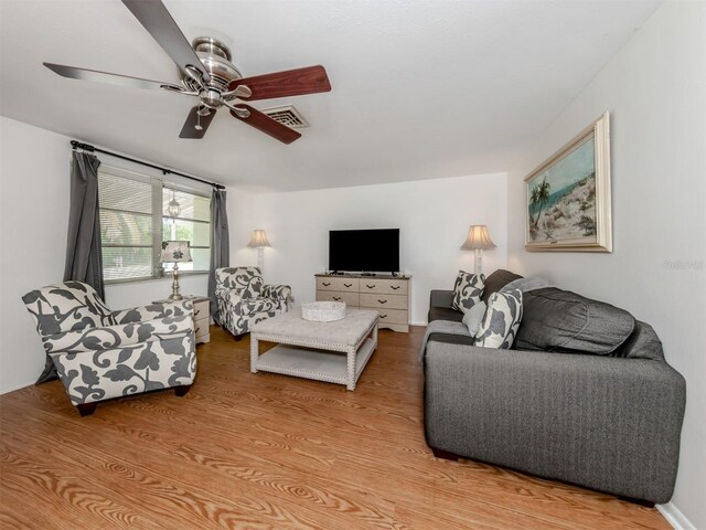 living room with ceiling fan and light hardwood / wood-style flooring