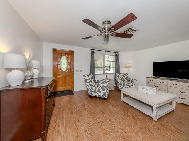 living room featuring light hardwood / wood-style floors and ceiling fan