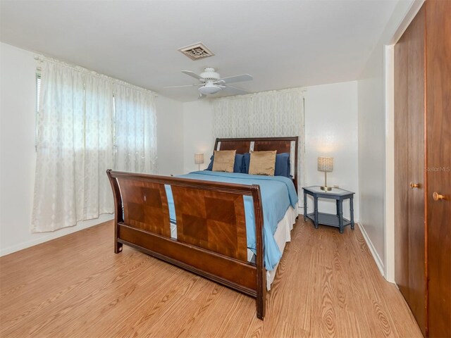 bedroom featuring a closet, light wood-type flooring, and ceiling fan