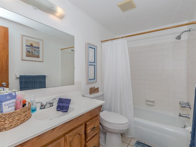 full bathroom featuring vanity, shower / bath combo with shower curtain, toilet, and tile patterned flooring