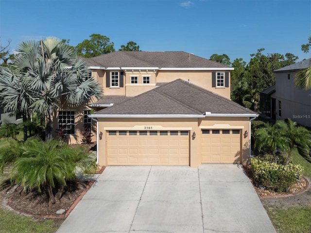 2585 Hobblebrush Dr, North Port, FL 34289 - traditional-style home featuring stucco siding, a shingled roof, a garage, and concrete driveway