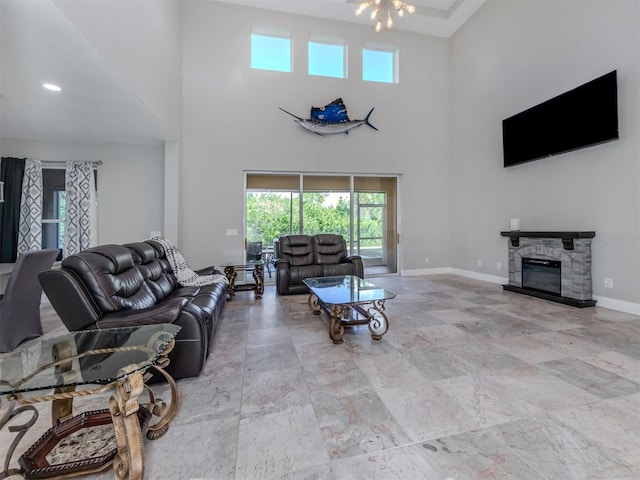 living room with a high ceiling and a fireplace