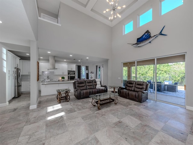 living room with a notable chandelier and a high ceiling