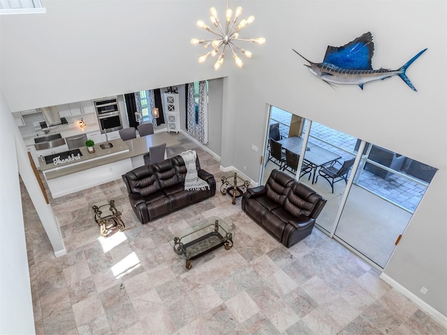 2585 Hobblebrush Dr, North Port, FL 34289 - living room featuring baseboards and a chandelier