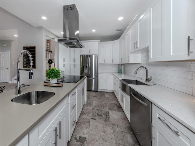 kitchen featuring island range hood, appliances with stainless steel finishes, sink, and white cabinetry