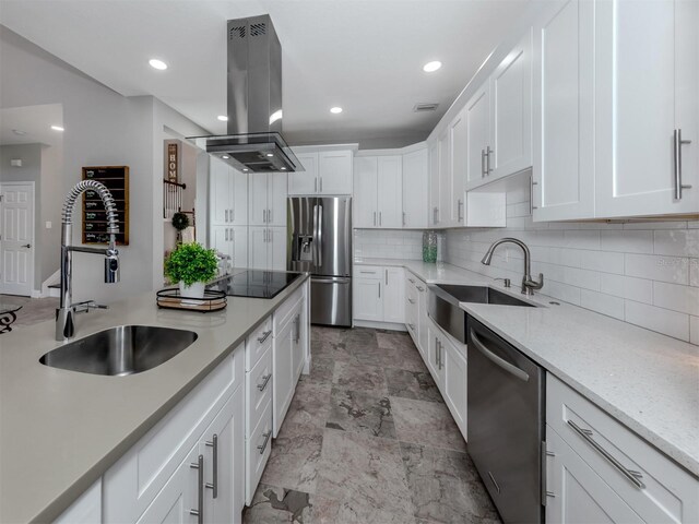 2585 Hobblebrush Dr, North Port, FL 34289 - kitchen featuring appliances with stainless steel finishes, white cabinets, a sink, and island exhaust hood