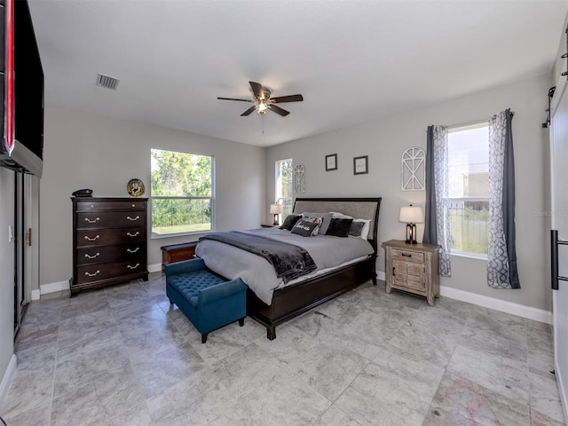 bedroom featuring ceiling fan and multiple windows