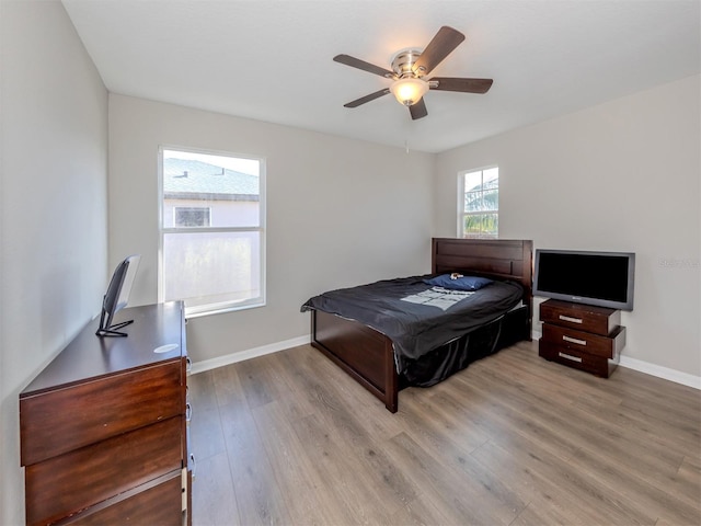 2585 Hobblebrush Dr, North Port, FL 34289 - bedroom featuring baseboards, wood finished floors, and a ceiling fan