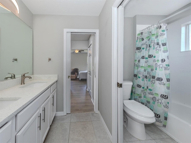 full bathroom featuring ceiling fan, vanity, tile patterned flooring, shower / tub combo, and toilet