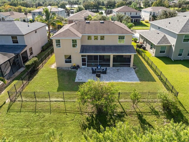 2585 Hobblebrush Dr, North Port, FL 34289 - rear view of property with a sunroom, stucco siding, a fenced backyard, a residential view, and a patio area