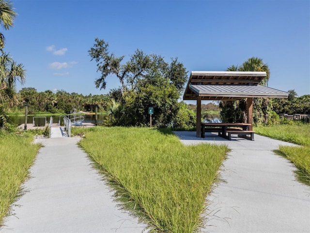 surrounding community featuring a water view and a gazebo