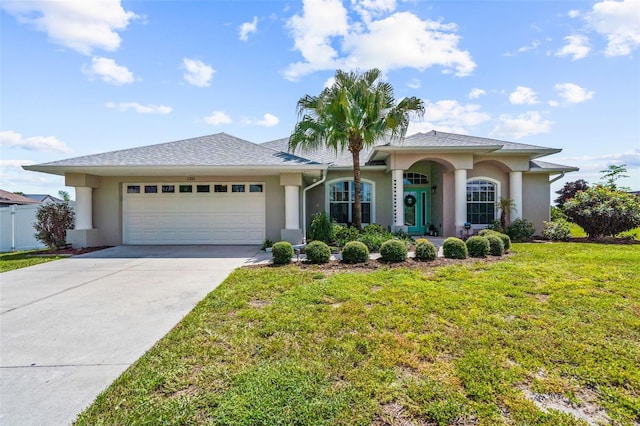 view of front of home with a garage and a front yard