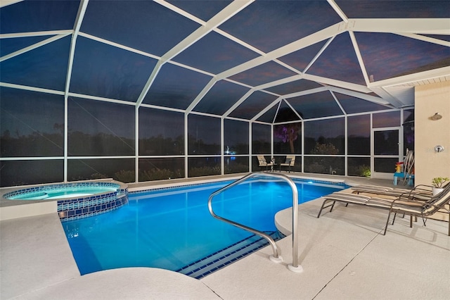 view of swimming pool with a lanai, a patio, and an in ground hot tub