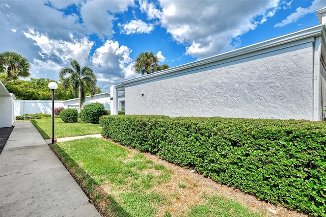 view of side of home featuring a yard