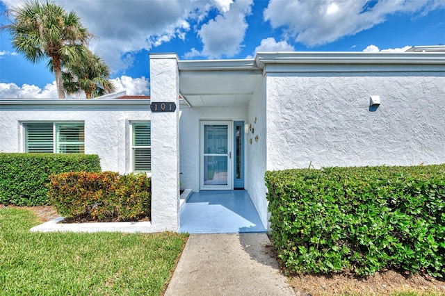 entrance to property with a yard