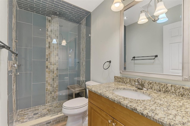 bathroom featuring walk in shower, vanity, and toilet