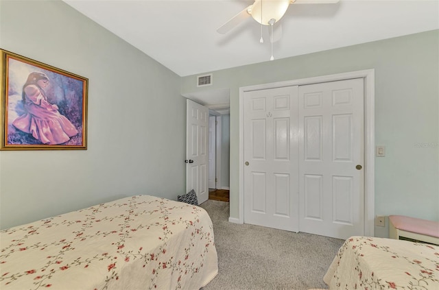 carpeted bedroom featuring a closet and ceiling fan