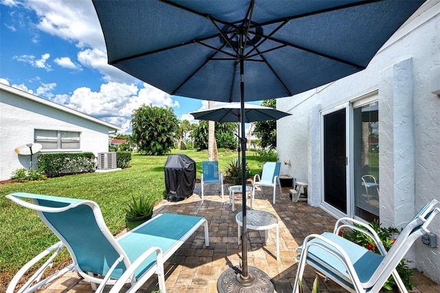 view of patio with central AC unit and area for grilling