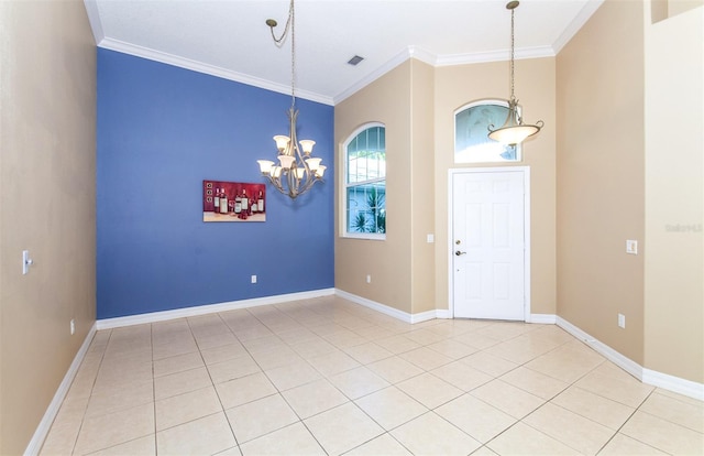 entrance foyer featuring an inviting chandelier, crown molding, and tile patterned floors