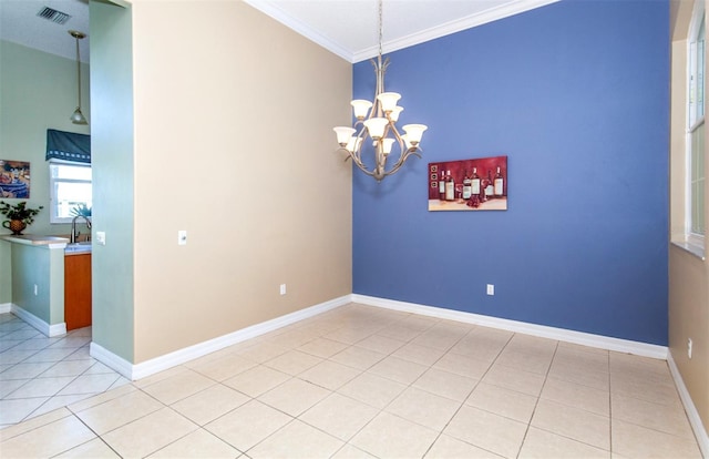 tiled spare room featuring ornamental molding and a chandelier