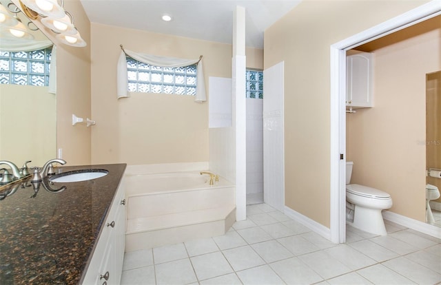 bathroom featuring vanity, tile patterned floors, toilet, and a tub