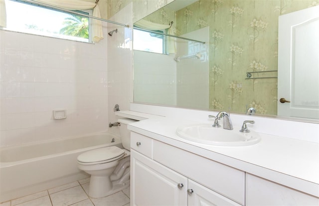 full bathroom featuring tile patterned flooring, tiled shower / bath combo, vanity, and toilet