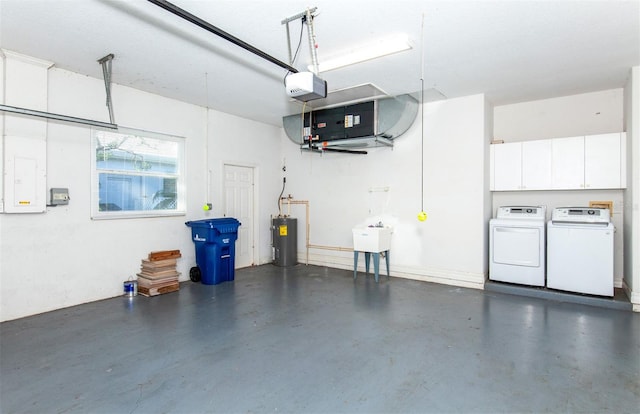 garage featuring a garage door opener, sink, water heater, and washer and clothes dryer