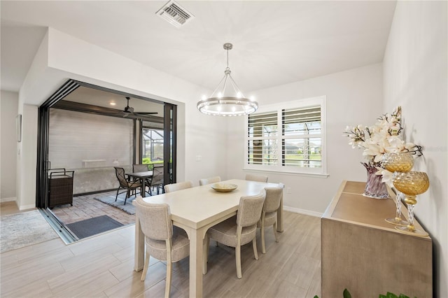 dining space with an inviting chandelier, light hardwood / wood-style flooring, and plenty of natural light