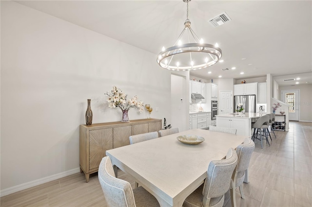 dining room with an inviting chandelier and light tile patterned floors