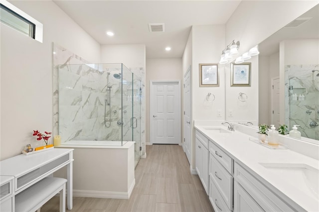 bathroom with vanity and a shower with door