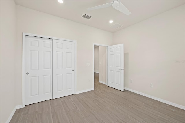 unfurnished bedroom with light hardwood / wood-style flooring, ceiling fan, and a closet