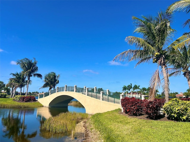 view of community featuring a lawn and a water view