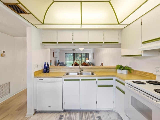 kitchen with light wood-type flooring, sink, white cabinets, custom range hood, and white appliances