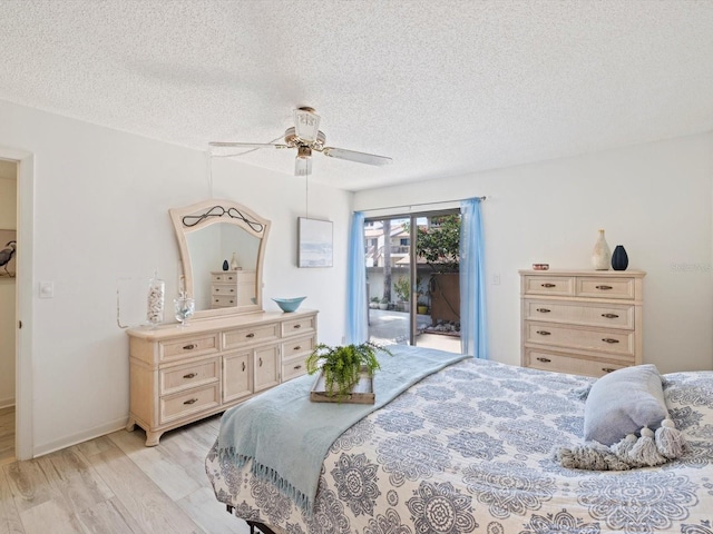 bedroom featuring access to outside, a textured ceiling, light wood-type flooring, and ceiling fan