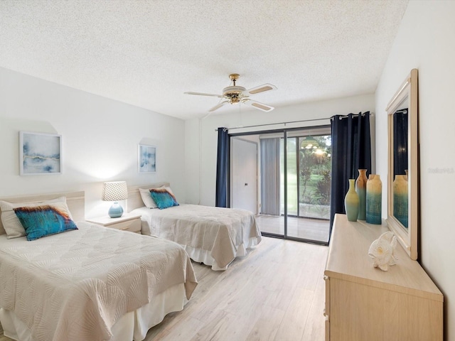 bedroom featuring light hardwood / wood-style flooring, ceiling fan, access to exterior, and a textured ceiling